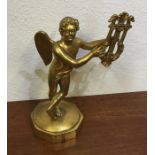 An attractive gilt model of a winged musician on s
