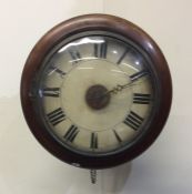 A mahogany surrounded wall clock with circular dia