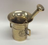 A good Antique brass pestle and mortar decorated w