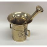 A good Antique brass pestle and mortar decorated w