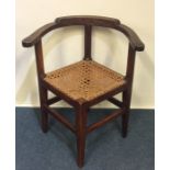 A Georgian oak corner chair with leather feet. Est