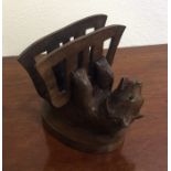 A small carved letter rack in the form of a bear w