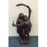 A tall bronze figure of a romantic couple. Marked