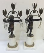 A pair of French candlesticks decorated with cheru