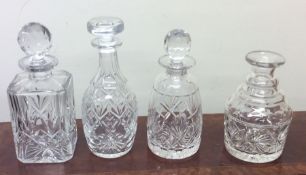 A group of four heavy glass decanters. Est. £15 -