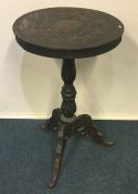 A Continental carved single drawer tripod table. E