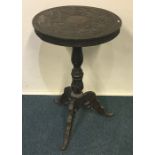 A Continental carved single drawer tripod table. E