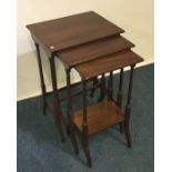 A nest of three Victorian mahogany tables with inl
