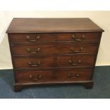 A Georgian mahogany four drawer chest on bracket f