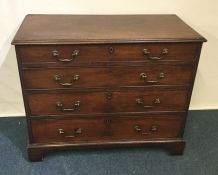 A Georgian mahogany four drawer chest on bracket f