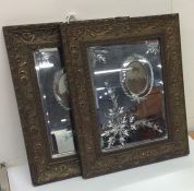 A pair of French mirrored photo frames decorated w