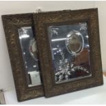 A pair of French mirrored photo frames decorated w