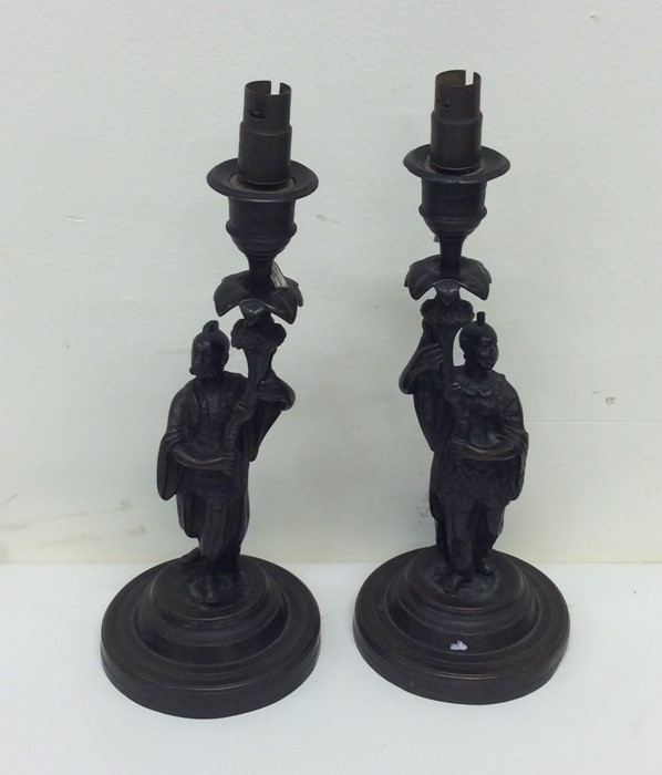 A pair of bronze candlesticks in the form of Japan