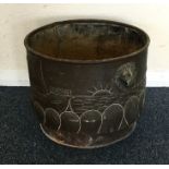 A copper log bin decorated with viking ships and l