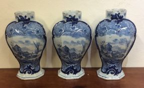 A garniture of three Delft vases decorated with sa