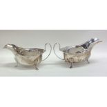 A pair of Edwardian silver sauce boats with shaped