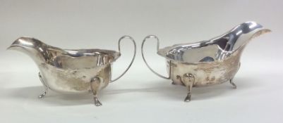 A pair of Edwardian silver sauce boats with shaped