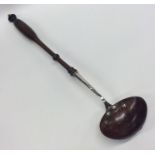 A silver and treen ladle with turned handle. Appro