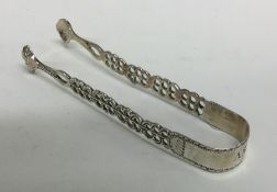 A good pair of Georgian pierced silver sugar tongs