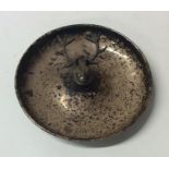 A circular silver pin dish mounted with a stag. Bi