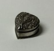 A Continental silver heart shaped pill box with fl