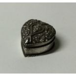 A Continental silver heart shaped pill box with fl