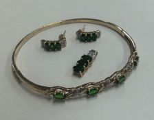 A diamond mounted and green stone bangle together
