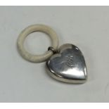 An unusual silver heart shaped rattle / teether. A