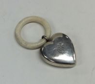 An unusual silver heart shaped rattle / teether. A