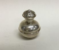 A small baluster shaped silver pepper of churn for