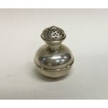 A small baluster shaped silver pepper of churn for