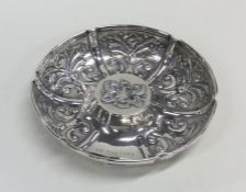 A good quality embossed silver dish decorated with