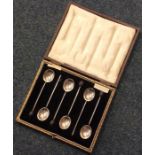 A cased set of six silver bean top coffee spoons.