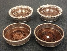 Two pairs of silver plated wine coasters. Est. £20