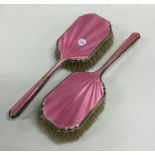 A pair of silver and enamelled hairbrushes of tape