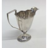 A shaped Edwardian silver cream jug. London. Appro