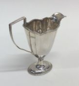 A shaped Edwardian silver cream jug. London. Appro