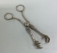 A pair of Continental silver plated ice tongs. Est