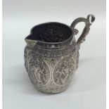 A good quality Indian silver mug decorated in reli