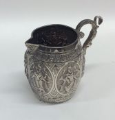 A good quality Indian silver mug decorated in reli