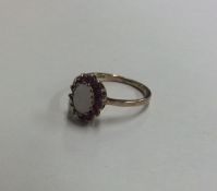 An opal and ruby cluster ring in claw mount. Appro