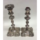 A pair of Victorian silver candlesticks with shape