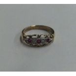 AN ornate ruby and diamond five stone ring in two