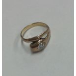 A small rose gold mounted snake ring inset with di