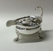 A good quality George II silver cream boat on thre