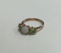 A peridot and opal three stone ring in 9 carat mou