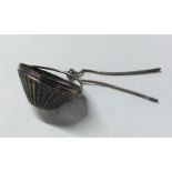 An unusual Continental silver tea strainer of tape