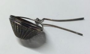 An unusual Continental silver tea strainer of tape