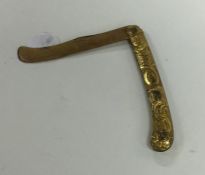 An early Georgian gilt fruit knife. Est. £20 - £30