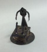 A miniature silver table toy of a figure mounted w